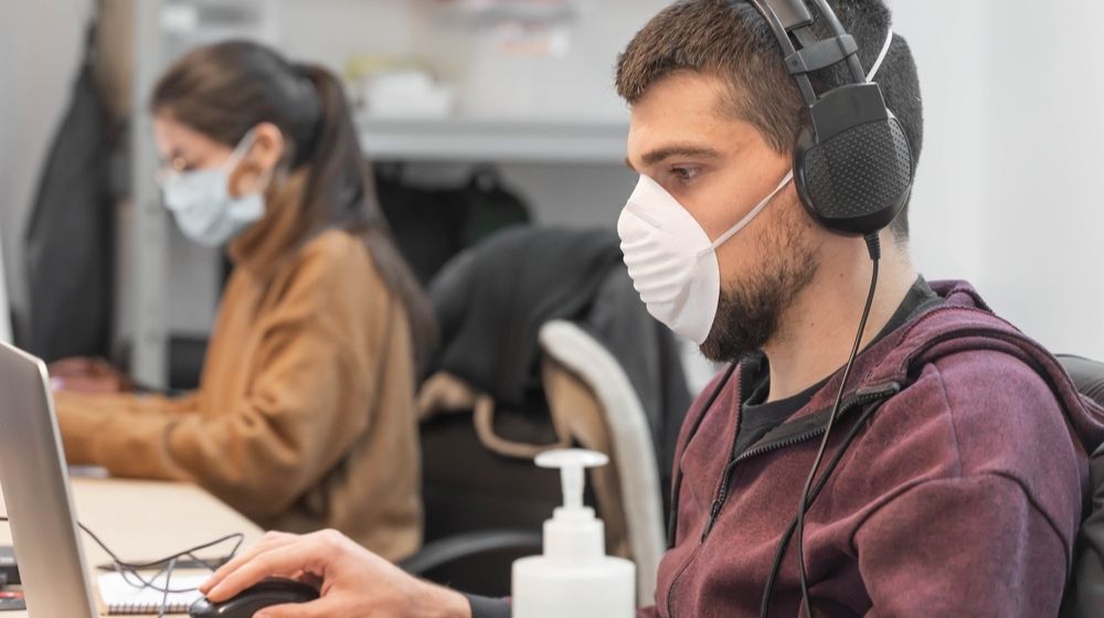 Business Workers Working from Home Wearing Protective Mask | Report Shows That Almost Quarter of Workforce Is at Higher Risk of Severe COVID-19 Illness | Featured