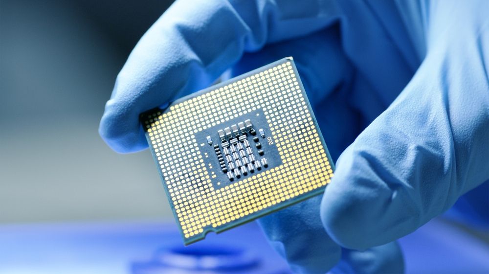 Gloved Hand Holding Piece of Technological Wonder | Lawmakers Seek to Bolster U.S. Microchip Industry | Featured