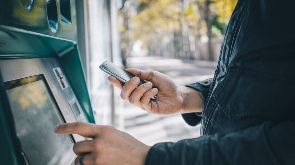 a male with smartphone infron of the
