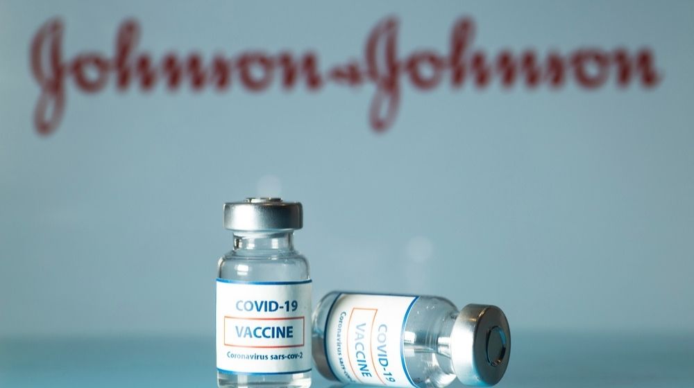 Concept of COVID vaccine vials with J&J logo in the background-Biden to Purchase 100 Million Johnson & Johnson COVID Vaccine Doses-ss-Featured