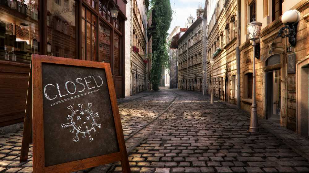Coronavirus crisis. CLOSED message board near bar, cafe, shop on empty street. Corona virus COVID-19 disease global pandemic outbreak | Epidemiologist Says World Nowhere Near End of COVID Pandemic | featured