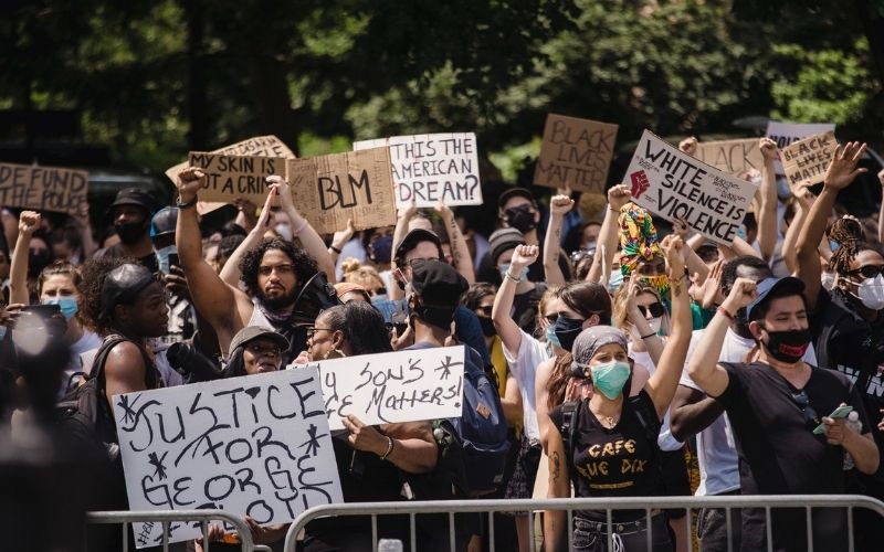 Crowd of Protesters Holding Sign | Police Arrest 5 During RNC Protests in Charlotte