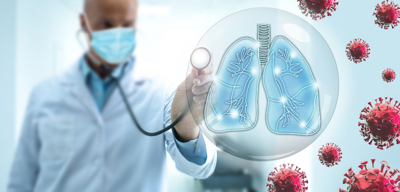 Doctor pulmonologist take care of the human lungs against the backdrop of flying COVID-19 viruses | flurona
