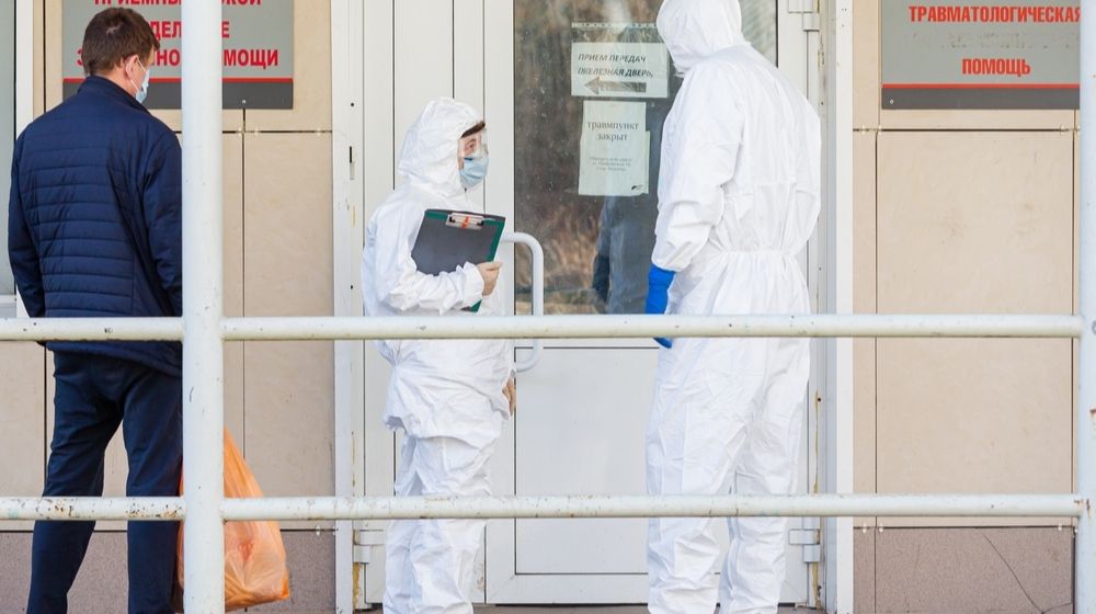 Doctors in Personal Protective Equipment Stand with Suspected Coronavirus Man | Is Russia Leading the COVID-19 Vaccine Race? | Featured