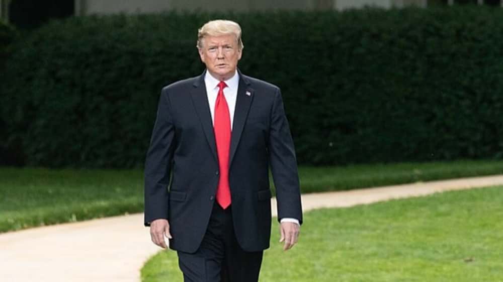 Donal Trump in suit walking featured | New Moody’s Analytics Model Predicts Easy Win for Trump in 2020 | featured
