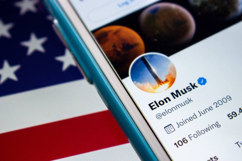 Elon Musk twitter account on iPhone on the US flag | Musk Now Largest Shareholder, Is Twitter Takeover Imminent? 
