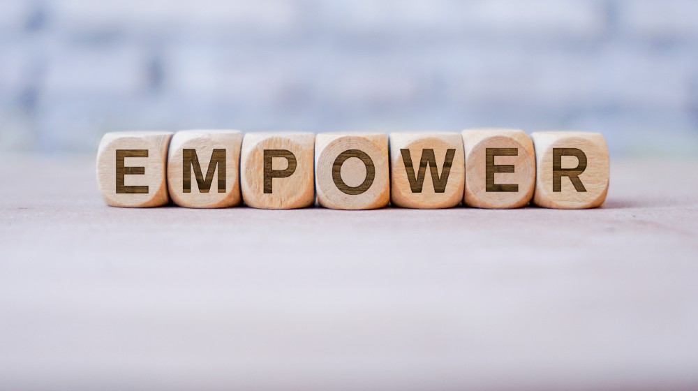 Empower word written on wood block | Critical Thinking: Does Society Want Empowered Victims? | featured