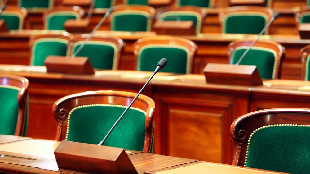 Empty vintage congress hall with seats and microphones | The political center is gone | featured