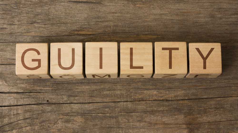 GUILTY word on wooden cubes | Ghislaine Maxwell Guilty Of Sex Trafficking & Four Other Federal Charges | featured