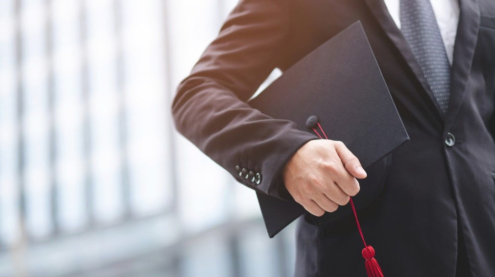 Graduates of the University, businessman holding hats along with success | New Graduates Want $100K Starting Pay When It’s Really $55K | featured