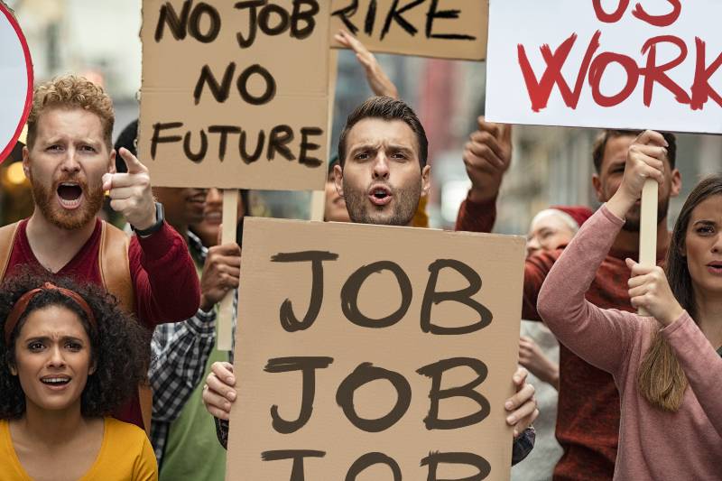Group of demonstrators with banners protest for job and equal salaries | Tight Labor Market Tightens Even Further