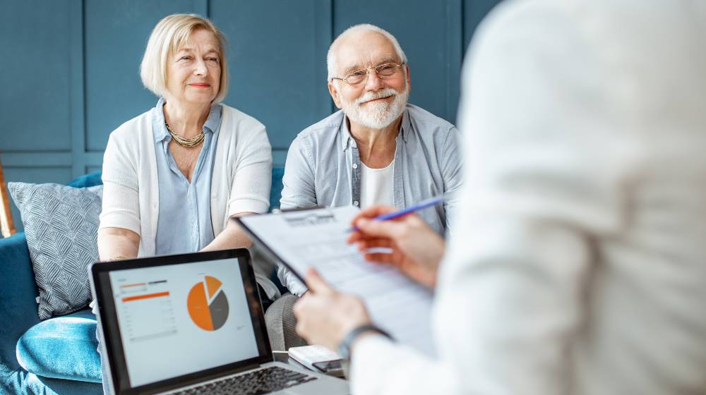 Happy senior couple during the meeting with agent or financial consultant | Retirement Planning In The 21st Century | featured