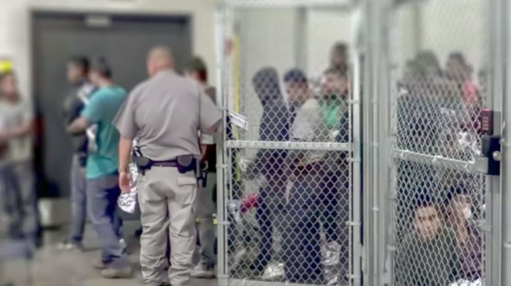 Illegal migrants at a holding facility-As Biden's Border Crisis Continues as Dems Look to Blame Trump -ss-Featured