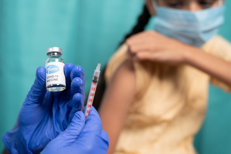 Kid with medical face mask getting vaccinated Pfizer's Covid-19-CNN 5 Things