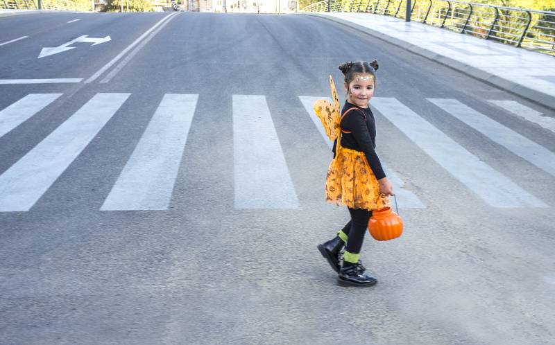Little girl at zebra crossing in halloween costumes-Trick Or Treating