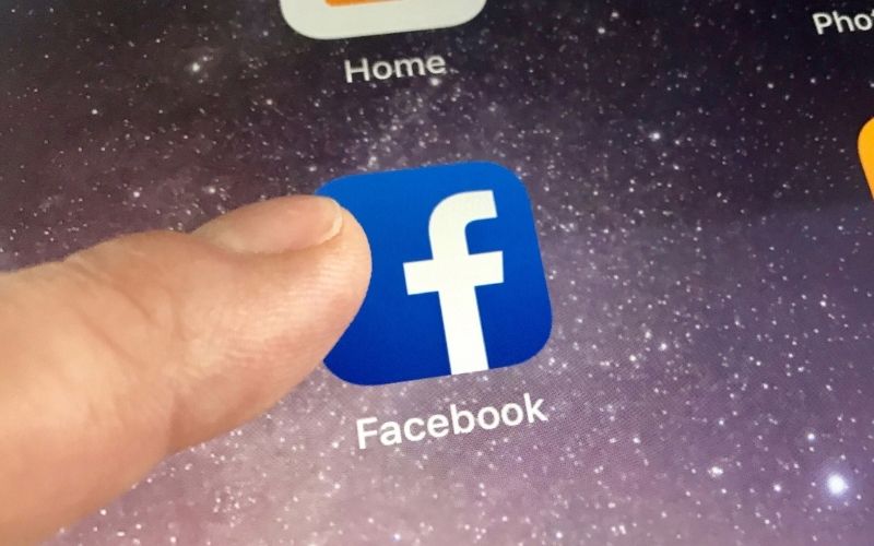 Macro Image of Finger About to Click the Facebook Icon | Facebook Tests New Feature Called “Neighborhoods”