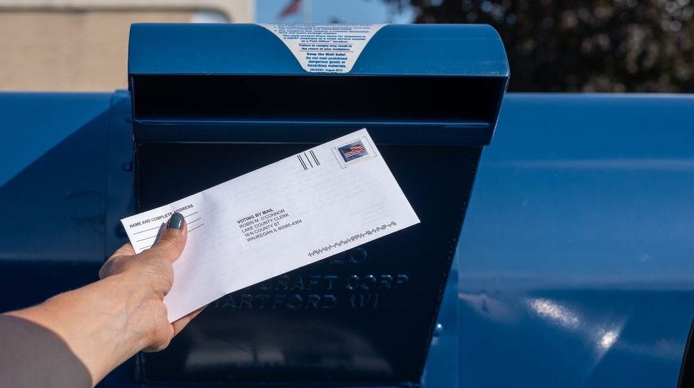 Woman Mailing Her Absentee Voter Ballot | Police Discovers Stolen Checks and Absentee Ballot in Texas Man’s Vehicle | Featured