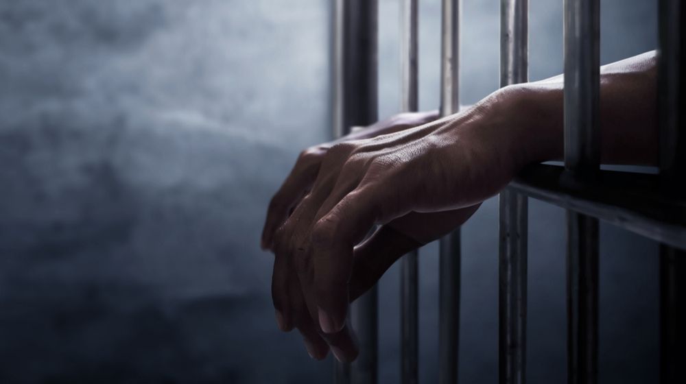 Mans Hands on a Cell Bar | Man in prison | Featured