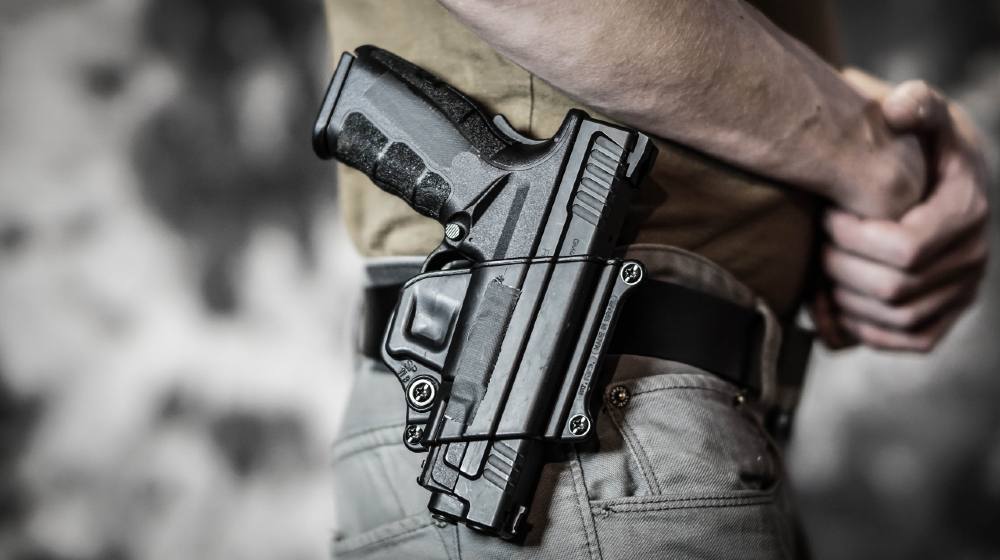 Nebraska - Man openly carrying a pistol on his belt. Open carry and second amendment concept-Constitutional Carry-ss-featured