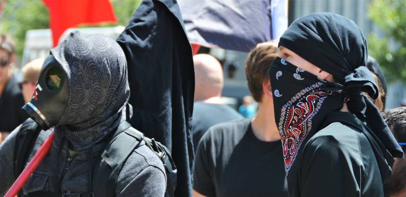 Masked Antifa left-wing militant group protesting at a Trump rally in Denver | Musk Wants Far-Left Groups Investigated 