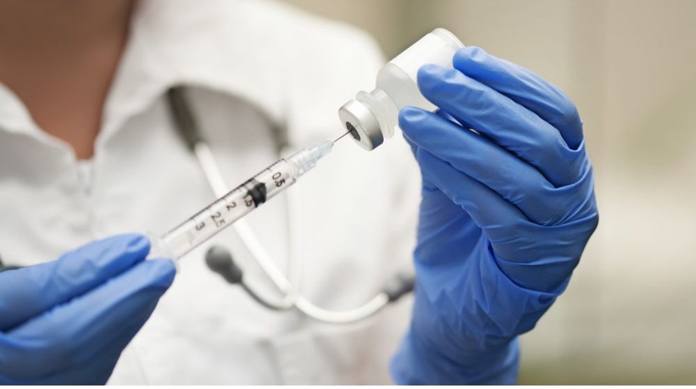 Medication Nurse Wearing Protective Gloves Get a Needle Ready for an Injection | American Medical Association Says the Flu Vaccine This Year “Is More Important Than Ever” | Featured