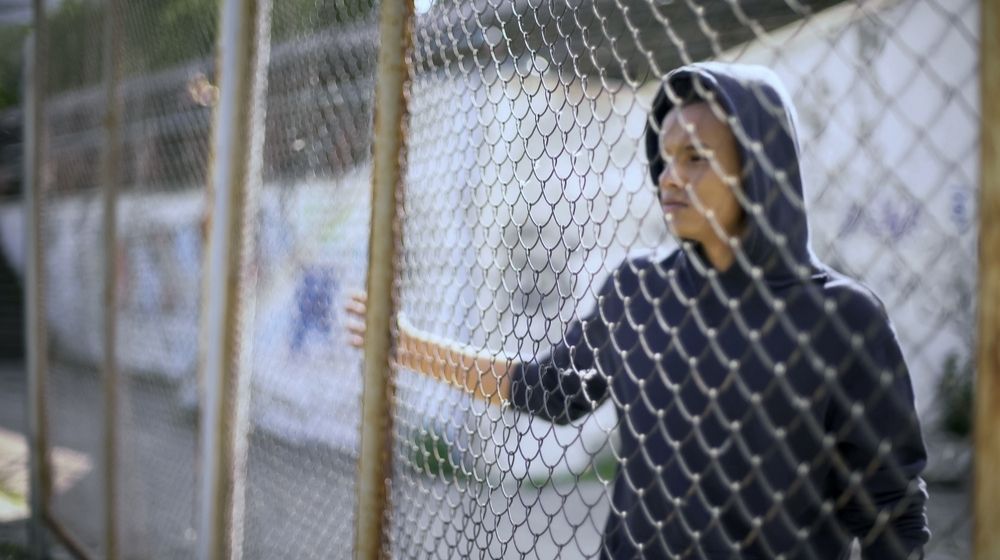 Migrant boy separated from family behind fence-New Photos Show Terrible Conditions for Biden's Immigrant Surge Facilities in Texas-ss-Featured