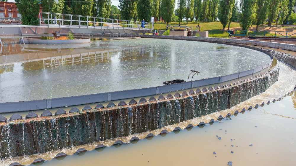 Modern wastewater treatment plant. Round tanks for sedimentation of dirty water | water woes | Featured