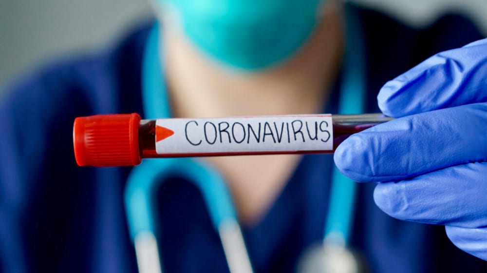 Nurse holding a blood test result of corona virus patient | Coronavirus Poses Threat to U.S. Economy | Featured
