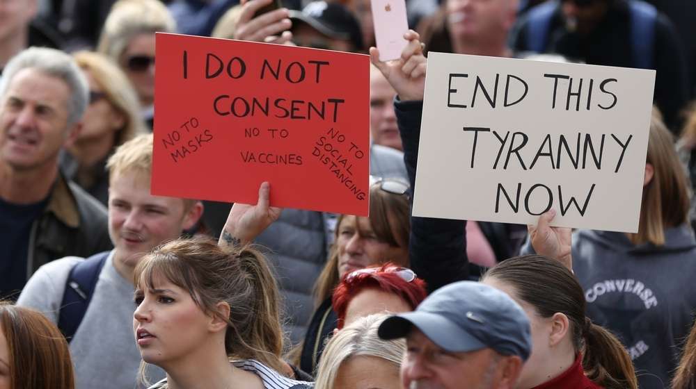People protesting against masks vaccines and quarantine-Alaska Governor Lets Biden Know What He Can Do With His Mask Mandate-ss-Featured