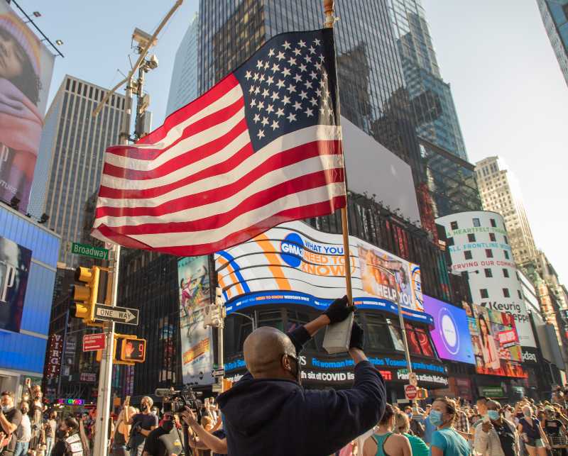 Revelers celebrate in Times Square after news organizations projected that the Biden-Harris ticket would win the White House-Winning Elections