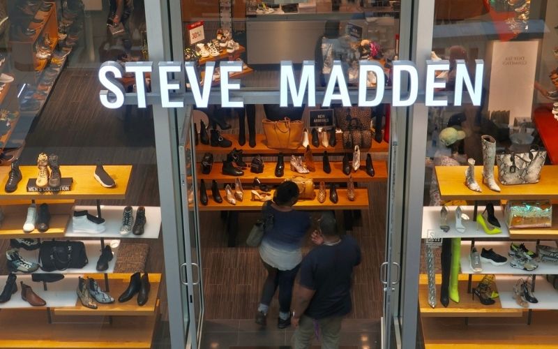 STEVE MADDEN Sign and Shoppers at Retail Store Location | Steve Madden Focuses on Flats as Consumers Seek Comfortable Footwear | Featured