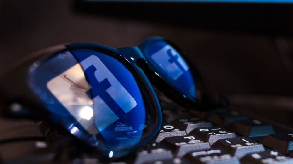 Facebook reflectiin on a sunglasses | Facebook Offers Opt-In Coronavirus Symptom Survey to U.S. Users | Featured
