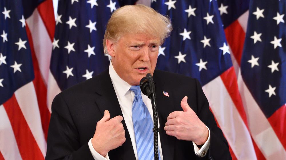 Stable Genius Trump President of the United States gestures as he addresses a press conference | Why Do So Many Elected Officials Continue Supporting Trump? | featured