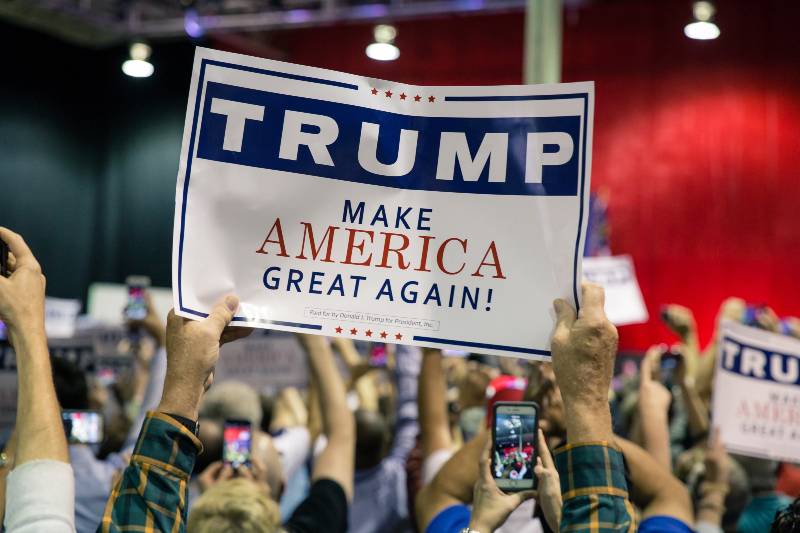 Supporter holding a campaign sign for a Presidential Candidate from Republican Party Donald Trump at a rally near Atlanta-Make America Great Again