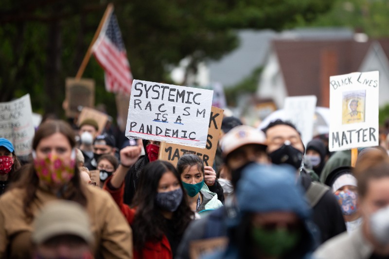 Systemic Racism is a Pandemic sign at the March of Silence, during the COVID-19 outbreak-denying-ss