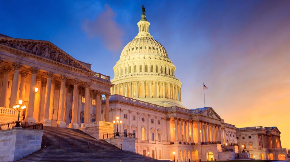 The United States Capitol building with the dome lit up at night-Point Counter Point-featured