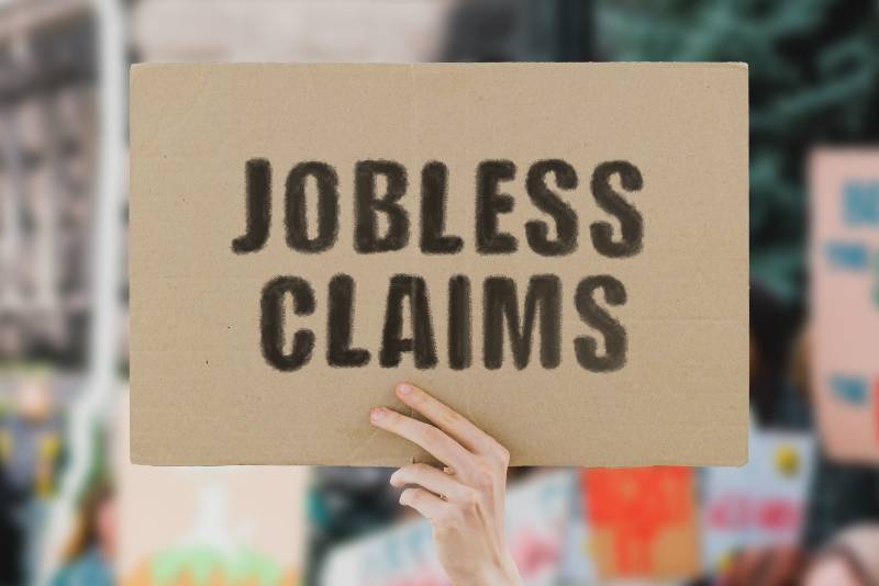 The phrase Jobless claims on a banner in hand-CNN 5 Things