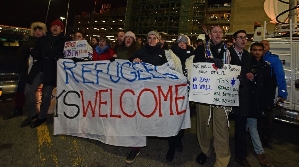 Activist protesting for detention of travelers | Clinton Appointed Judge Blocks Trump Order That Lets States, Cities Reject Refugees | Featured
