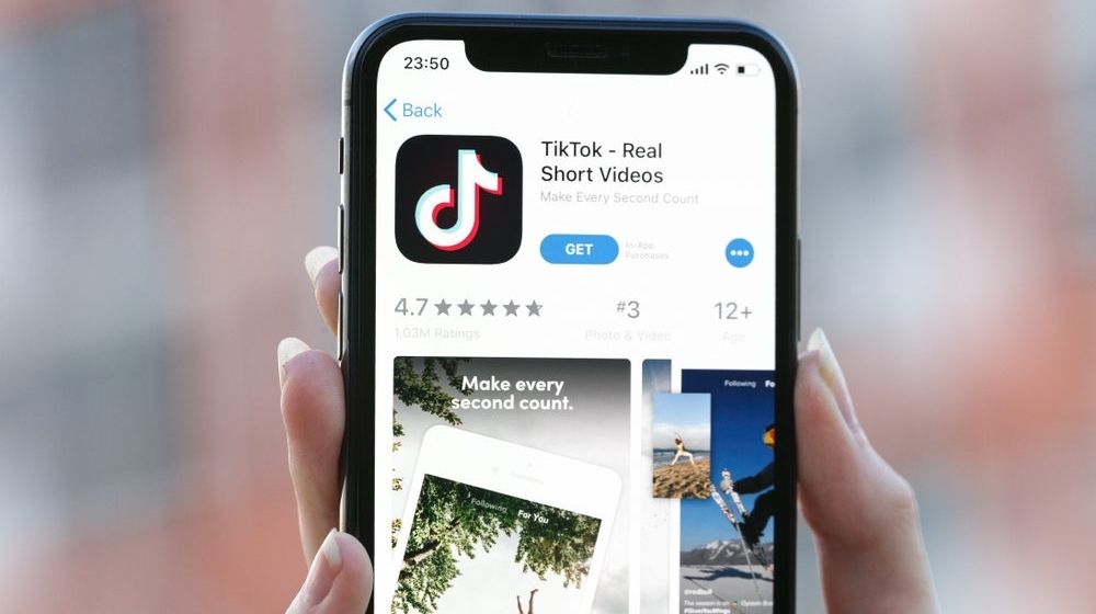 TikTok Application Icon on Apple iPhone X Screen | TikTok Works with Fact-Checking Partners to Prevent Election-Related Misinformation | Featured