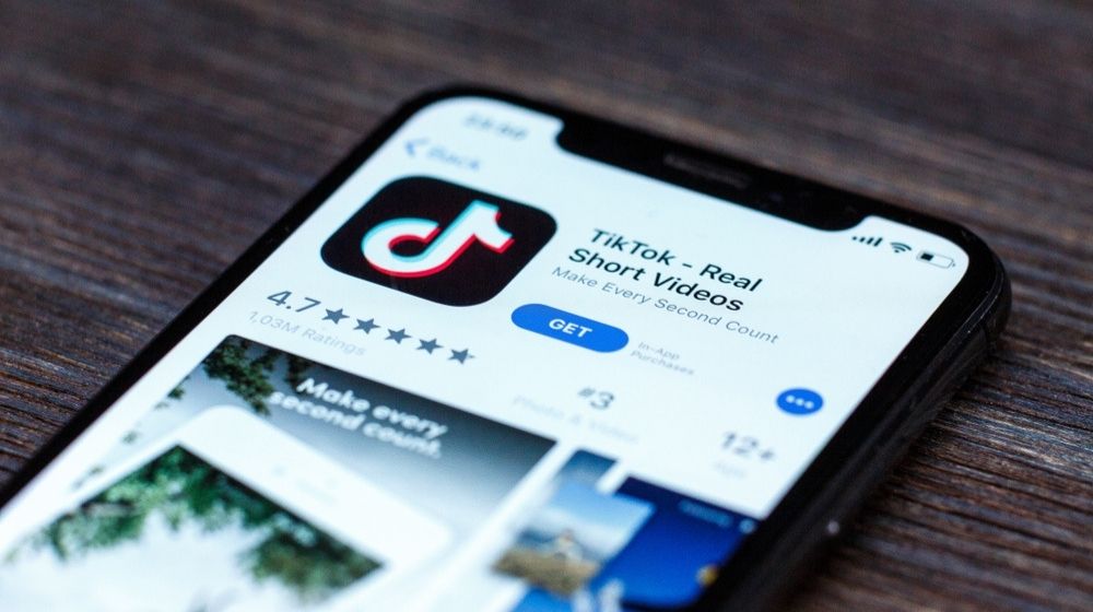 TikTok Application Icon on Apple iPhone X Screen Close-Up | Q&A: What Would a US Ban on Chinese-Owned App TikTok Mean? | Featured