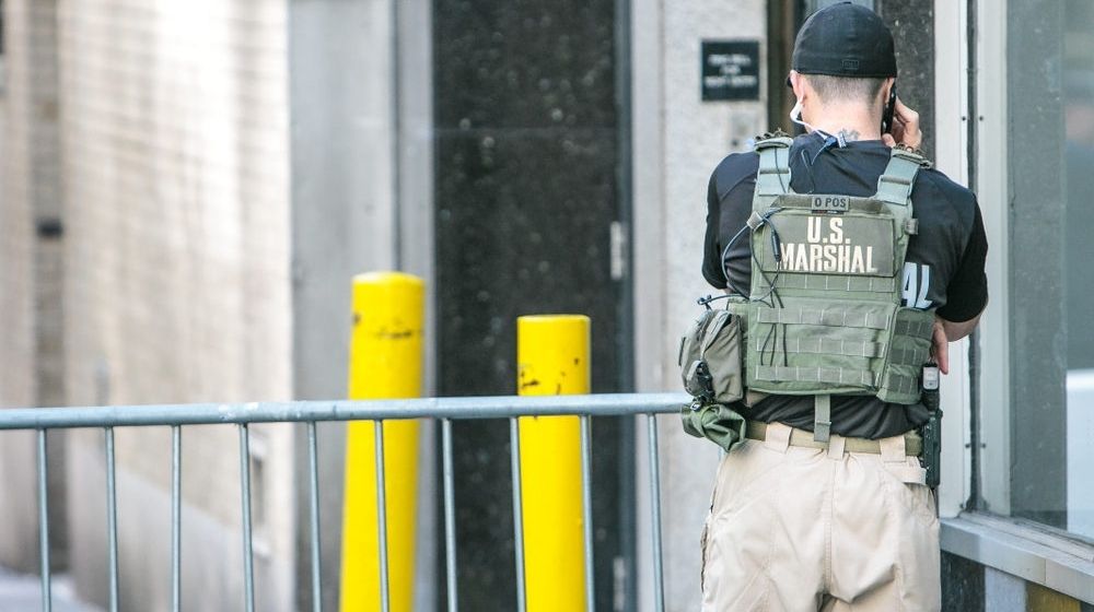 US Marshal is Talking on the Phone | U.S. Marshals Find 27 Missing Children During “Operation Find Our Children” | Featured