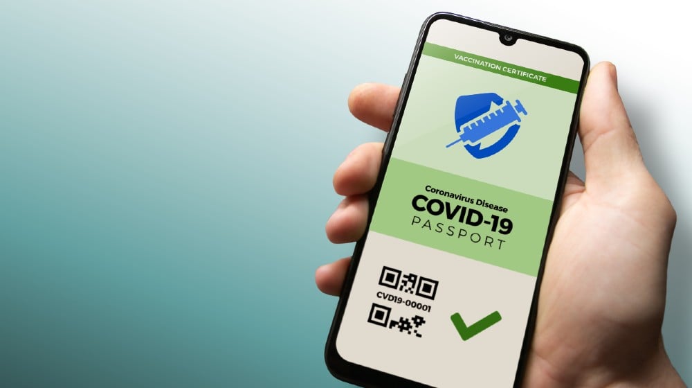 Vaccination passport for COVID-19 displayed on smartphone held in male's | Bill To Prohibit TSA From Requiring Vaccine Passports | Featured