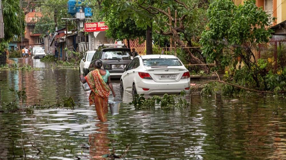 Woman Carrying Drinking Water through Water logged | Mumbai Spared, But Heavy Storms Ahead in 2020 | Featured
