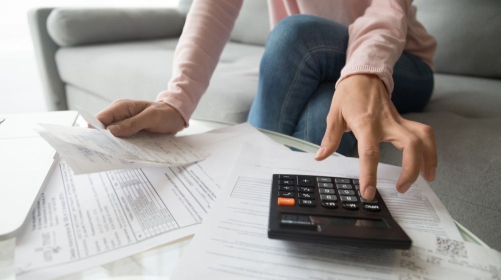 woman checking bills | Nonprofit Organizations Struggle Financially During COVID-19 Pandemic | Featured