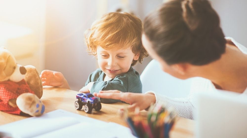 Delighted Young Thoughtful Mother Playing with Her Little Child Using Toys | Parents Worry About Childcare Costs After Pandemic, According to Survey | Featured