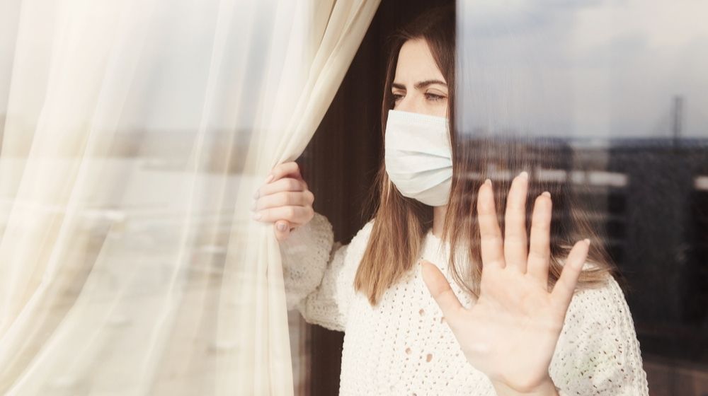 Young Woman in Medical Mask | Coronavirus Lockdown Leads to Double-Digit Weight Gain for Americans | Featured