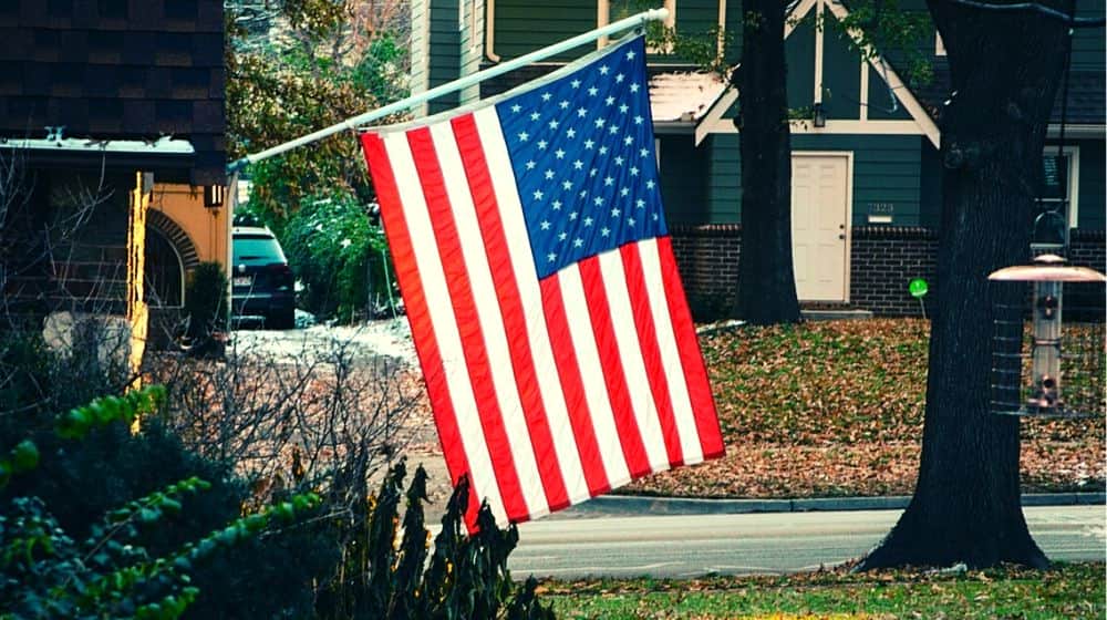 American flag raised outside a home | America Rises Up Against Lockdown | Featured