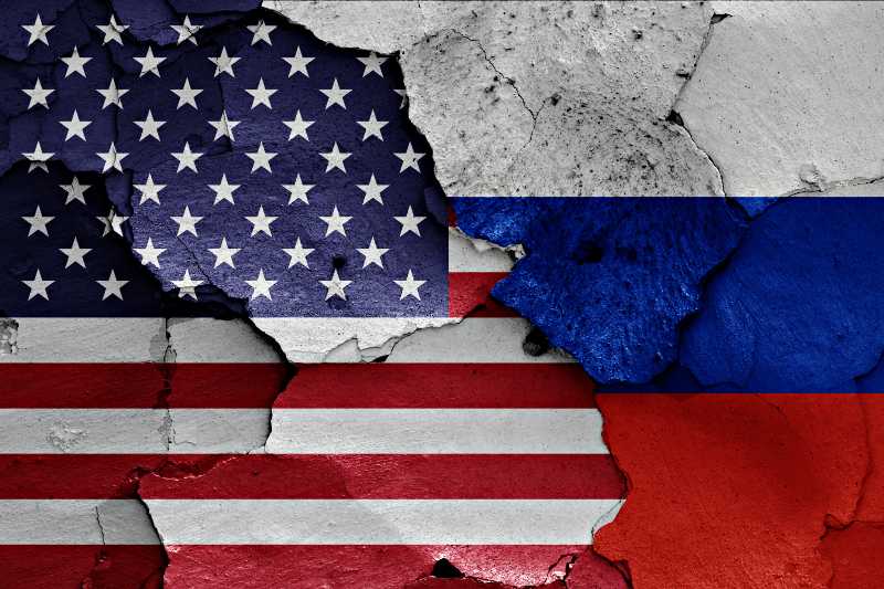 flags of USA and Russia painted on cracked wall | Under Threat of US Sanctions, Russia Will Not Back Down 
