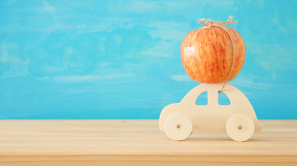 image of red fresh apple over wooden car. Rosh hashanah-Apple to Build Smart Cars-ss-featured