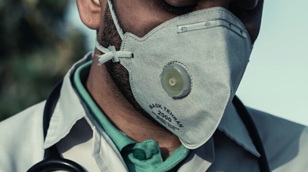 A doctor wearing mask | California Detective Dies from COVID-19 After Doctors Refuse to Test Her | Featured